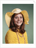 1970s Smiling Young Woman Wearing Yellow Floppy Brim Hat And Blouse With Pink Beads Looking At Camera by Anonymous