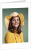 1970s Smiling Young Woman Wearing Yellow Floppy Brim Hat And Blouse With Pink Beads Looking At Camera by Anonymous