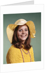 1970s Smiling Young Woman Wearing Yellow Floppy Brim Hat And Blouse With Pink Beads Looking At Camera by Anonymous