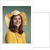 1970s Smiling Young Woman Wearing Yellow Floppy Brim Hat And Blouse With Pink Beads Looking At Camera by Anonymous