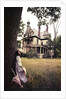 1960s 1970s Woman Standing Beside Tree Front Of Abandoned Haunted Victorian House by Anonymous