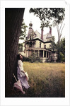 1960s 1970s Woman Standing Beside Tree Front Of Abandoned Haunted Victorian House by Anonymous