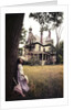 1960s 1970s Woman Standing Beside Tree Front Of Abandoned Haunted Victorian House by Anonymous
