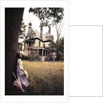 1960s 1970s Woman Standing Beside Tree Front Of Abandoned Haunted Victorian House by Anonymous