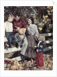 1950s Family Father Mother Son And Daughter Outdoor Carving A Pumpkin by Anonymous