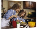 1970s Mother Daughter Dressed Alike Decorating Cake by Anonymous