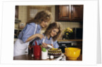1970s Mother Daughter Dressed Alike Decorating Cake by Anonymous