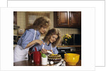 1970s Mother Daughter Dressed Alike Decorating Cake by Anonymous