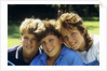 1980s Two Brothers And Their Sister Posed Heads Together Smiling Looking At Camera by Anonymous
