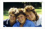 1980s Two Brothers And Their Sister Posed Heads Together Smiling Looking At Camera by Anonymous
