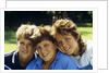 1980s Two Brothers And Their Sister Posed Heads Together Smiling Looking At Camera by Anonymous