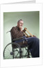 1960 1960s Retro Senior Man Sitting In Wheelchair With Crutches Blanket Wrapped Around Legs by Anonymous