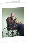 1960 1960s Retro Senior Man Sitting In Wheelchair With Crutches Blanket Wrapped Around Legs by Anonymous