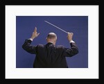 1950s 1960s 1970s View Of Back Of Bald Man Conducting A Symphony Orchestra by Anonymous
