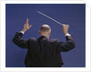 1950s 1960s 1970s View Of Back Of Bald Man Conducting A Symphony Orchestra by Anonymous