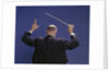 1950s 1960s 1970s View Of Back Of Bald Man Conducting A Symphony Orchestra by Anonymous