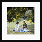 1960 1960s 1970 1970s Retro Smiling Couple Man Woman Sitting On Blanket On Grass Park Man Playing Acoustic Guitar by Anonymous
