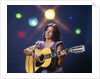 1970s Woman Girl Performer Playing Guitar Singing Microphone Stage Lights by Anonymous