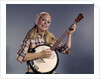 1960s Young Blonde Woman Wearing Plaid Shirt Playing Banjo Singing Folk Music Looking At Camera by Anonymous