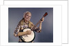 1960s Young Blonde Woman Wearing Plaid Shirt Playing Banjo Singing Folk Music Looking At Camera by Anonymous