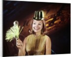 1960s Young Blonde Woman Party Hat Noisemaker Horn Smiling New Year Clock Background by Anonymous