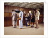 1970s Men Women Children Waiting In A Line In Bank For A Teller by Anonymous