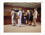 1970s Men Women Children Waiting In A Line In Bank For A Teller by Anonymous