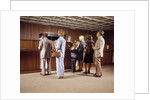 1970s Men Women Children Waiting In A Line In Bank For A Teller by Anonymous