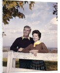 portrait Couple Husband & Wife Smiling Standing Together Behind White Board Fence Outdoor by Anonymous