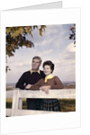 portrait Couple Husband & Wife Smiling Standing Together Behind White Board Fence Outdoor by Anonymous