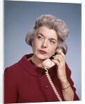 1960s Senior Middle Aged Woman Red Blouse Serious Expression Talking On Telephone by Anonymous