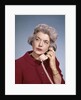 1960s Senior Middle Aged Woman Red Blouse Serious Expression Talking On Telephone by Anonymous