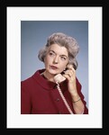1960s Senior Middle Aged Woman Red Blouse Serious Expression Talking On Telephone by Anonymous