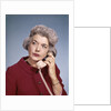 1960s Senior Middle Aged Woman Red Blouse Serious Expression Talking On Telephone by Anonymous