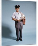 1970s Standing Full Length Portrait Of Middle Aged Mailman Carrying Mail Bag Wearing Uniform by Anonymous