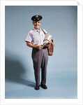 1970s Standing Full Length Portrait Of Middle Aged Mailman Carrying Mail Bag Wearing Uniform by Anonymous