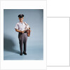 1970s Standing Full Length Portrait Of Middle Aged Mailman Carrying Mail Bag Wearing Uniform by Anonymous