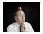 1960s Anxious Business Man Praying Looking Up At Arrow Heading Towards Apple Sitting On Top Of His Head by Anonymous