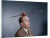 1960s Anxious Nervous Man Looking Up At Arrow Shot Through An Apple Sitting On Top Of His Head by Anonymous