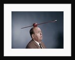 1960s Anxious Nervous Man Looking Up At Arrow Shot Through An Apple Sitting On Top Of His Head by Anonymous