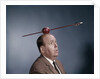 1960s Anxious Nervous Man Looking Up At Arrow Shot Through An Apple Sitting On Top Of His Head by Anonymous