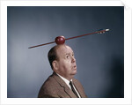 1960s Anxious Nervous Man Looking Up At Arrow Shot Through An Apple Sitting On Top Of His Head by Anonymous