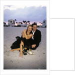1990s Laughing Couple Man Woman In Formal Wear Sitting Hugging On Beach by Anonymous