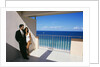 1990s Man In Dark Suit And Tie And Woman In White One Piece Bathing Suit Standing Together On Ocean Side Sun Deck by Anonymous