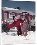 1950s Woman Hiding Behind Sled Throwing Snowball Front Stone House by Anonymous