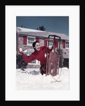 1950s Woman Hiding Behind Sled Throwing Snowball Front Stone House by Anonymous