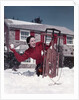 1950s Woman Hiding Behind Sled Throwing Snowball Front Stone House by Anonymous