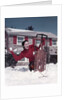 1950s Woman Hiding Behind Sled Throwing Snowball Front Stone House by Anonymous