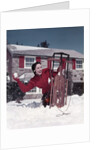 1950s Woman Hiding Behind Sled Throwing Snowball Front Stone House by Anonymous