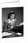 1940s Serious Secretary Stenographer Woman With Pencil Checking Notepad Sitting At Desk With Manual Typewriter Looking At Camera by Anonymous